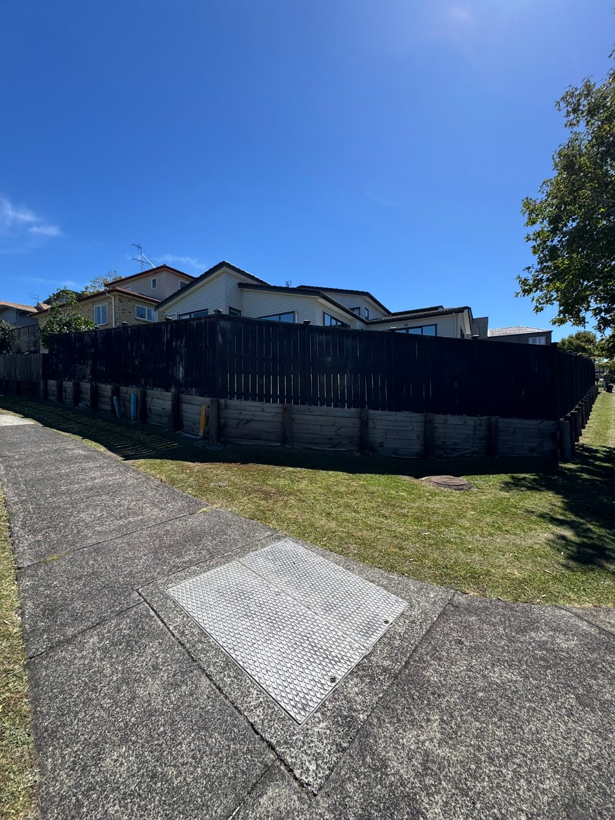 Weathered fence and retaining wall before painting